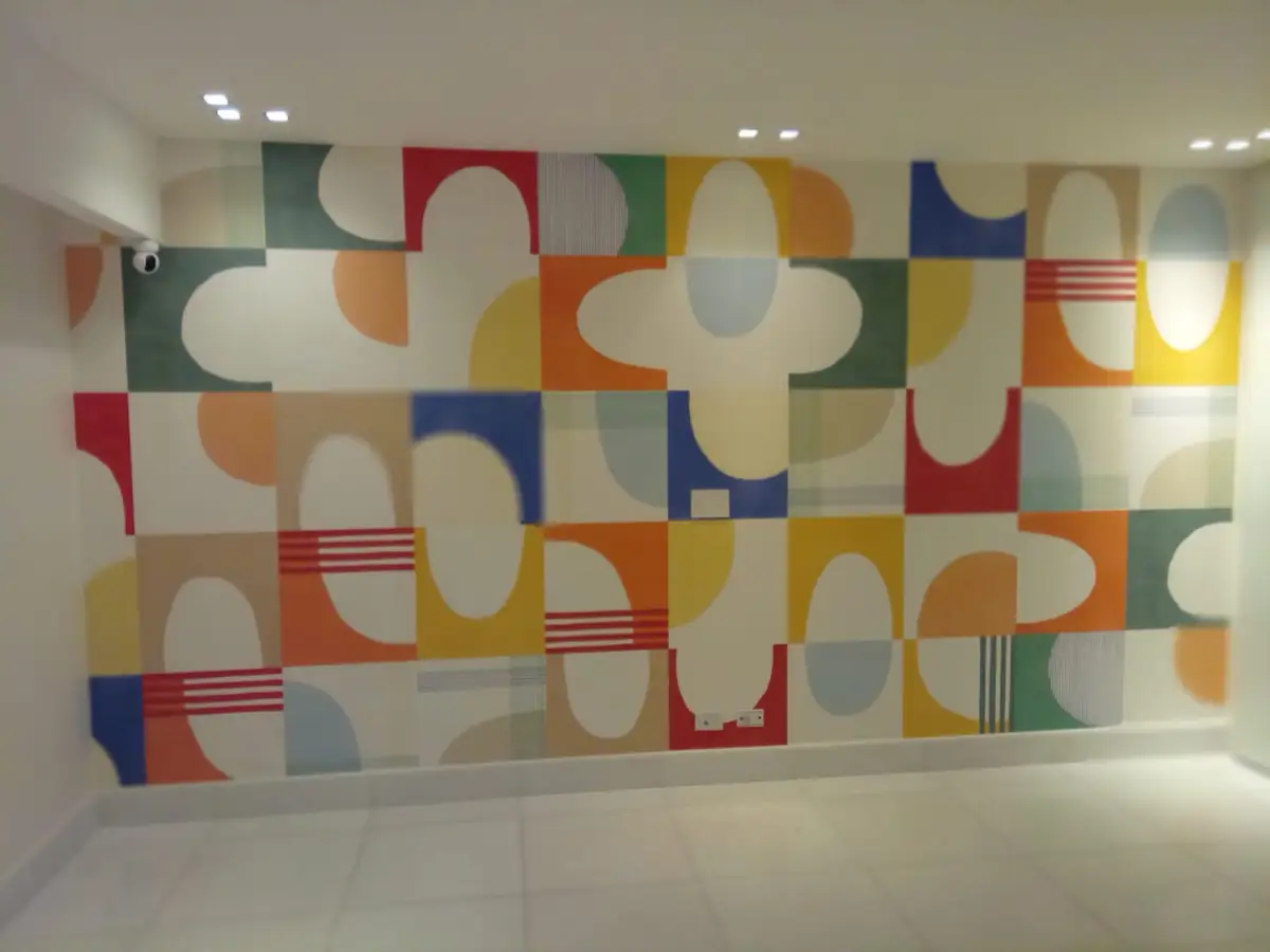 A bold geometric wallpaper in blocks of color across a feature wall