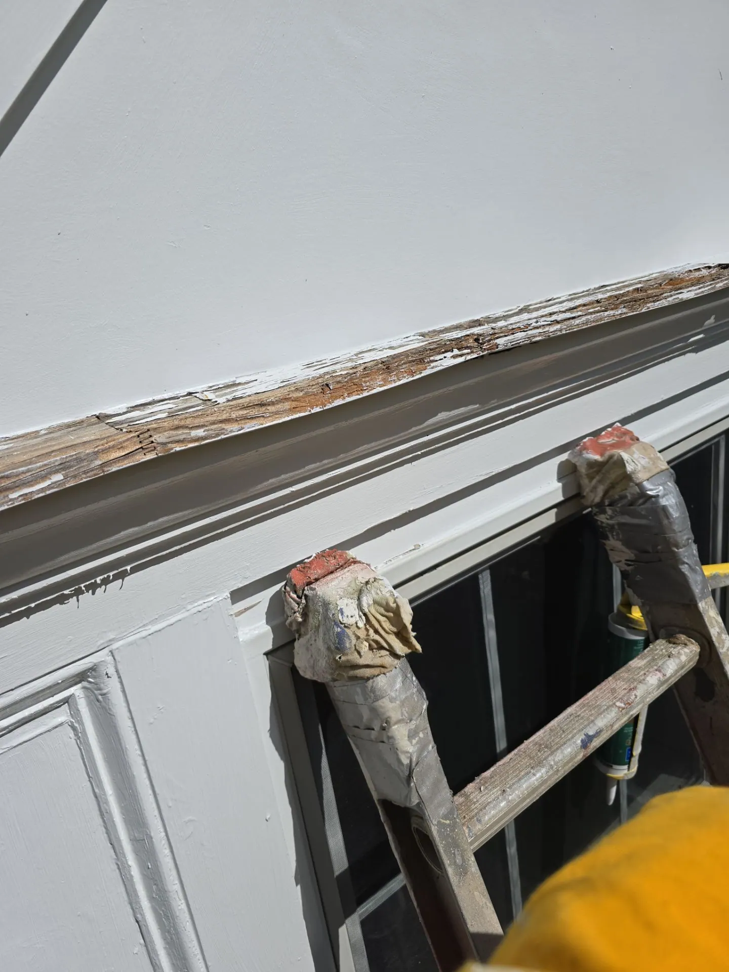 A rotted window header being cut out and replaced on a Bryn Mawr home